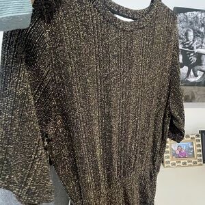 Sparkly black and cold short dress, cinched on the lower side.